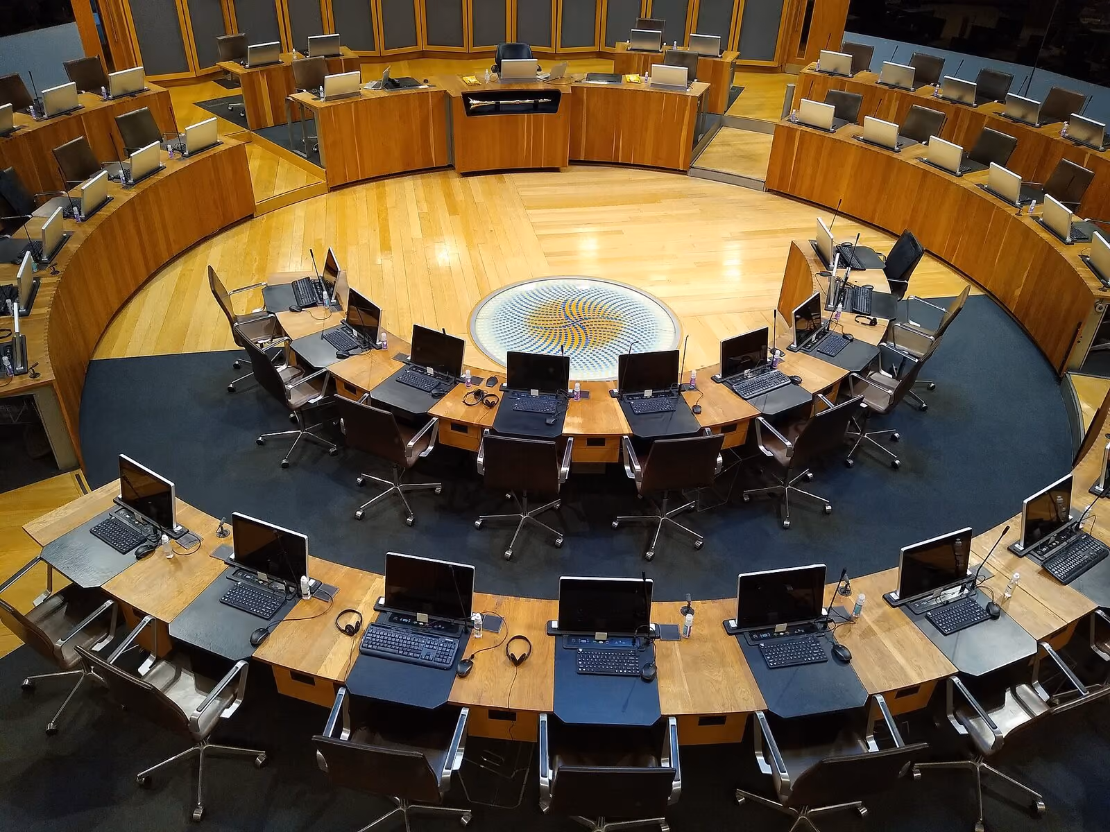 The debating chamber of a parliament, desks arranged in a circle.